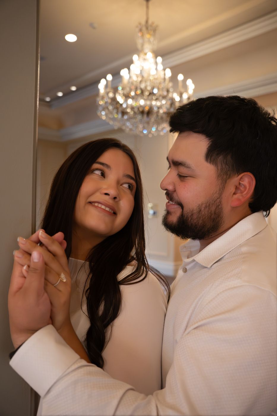 Nicky and Gabe dancing beneath a chandelier